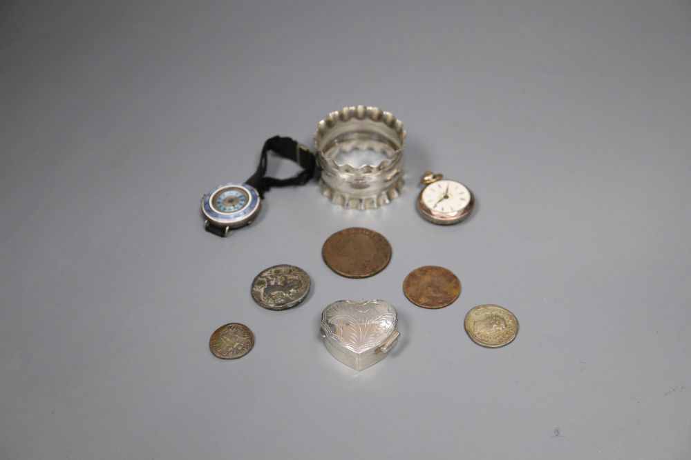 A silver and enamel wrist watch, a silver napkin ring, silver pill box and five assorted worn coins.